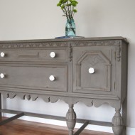 A driftwood buffet with white knobs