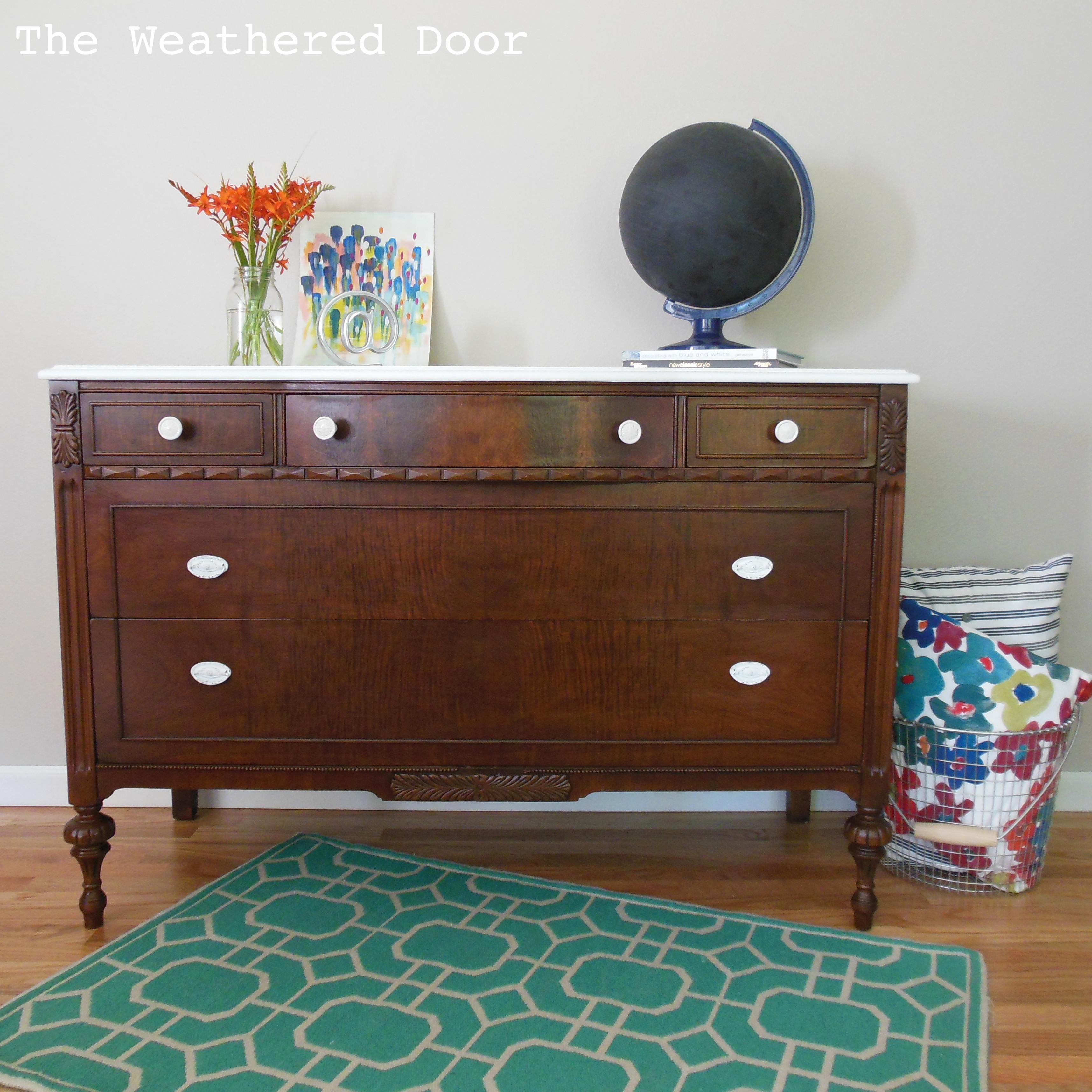 A Dark Wood Dresser With A White Top The Weathered Door