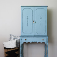 A long-legged light blue cabinet
