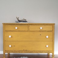 A chippy, mustard yellow dresser