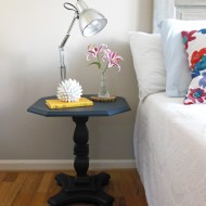 A navy pedestal side table