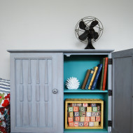A Weathered Grey Cabinet with a Pop of Teal